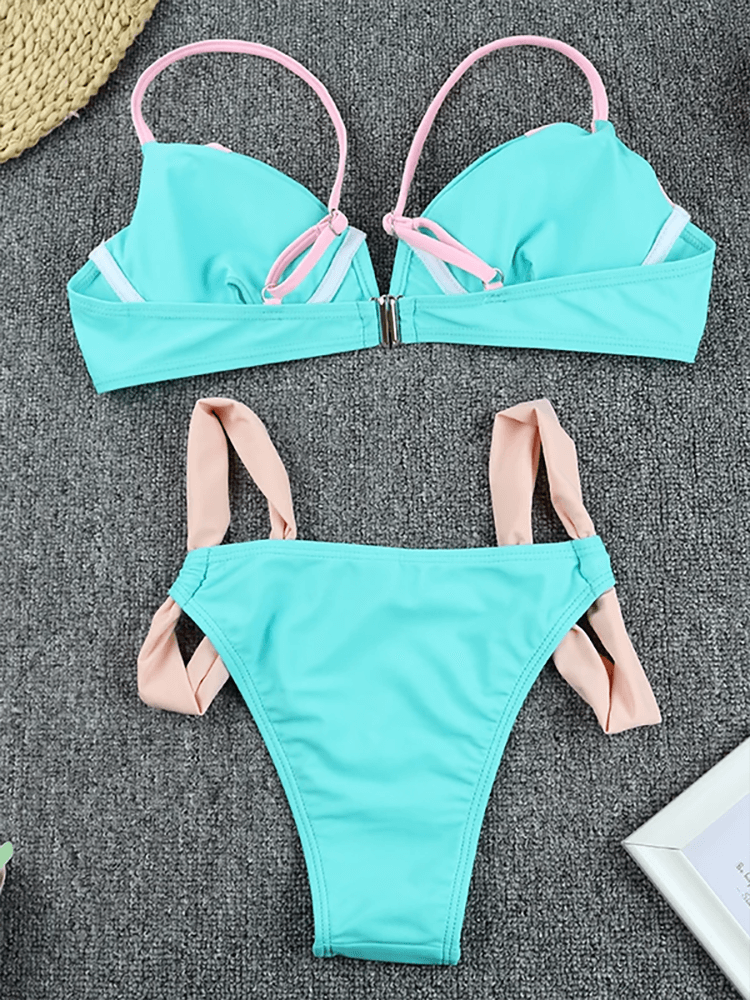 Chic two-tone pink and mint bikini set with adjustable straps on a gray background, perfect for summer beachwear.